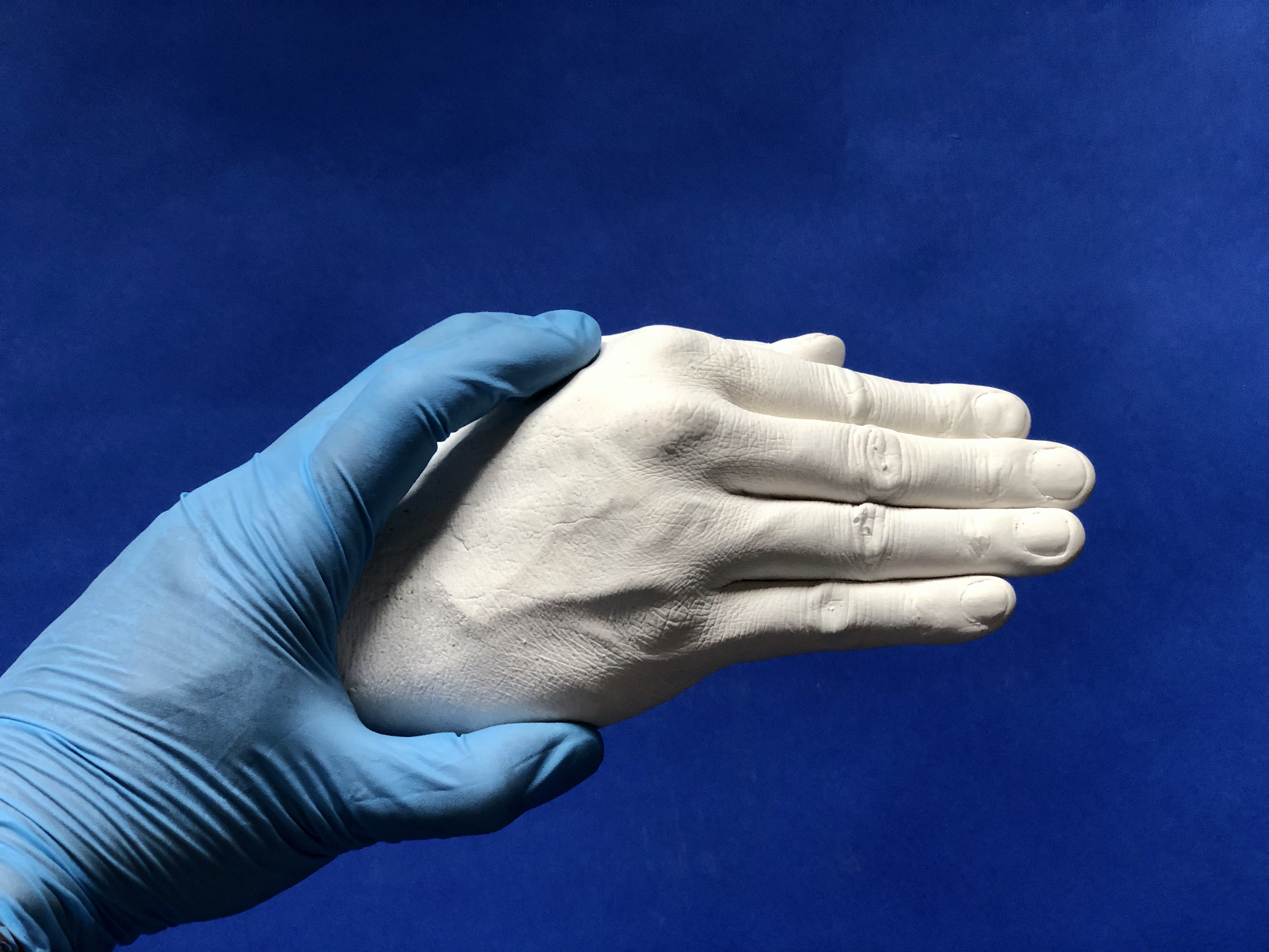 Kotama Bouabane: image of gloved hand gripping hand sculpture